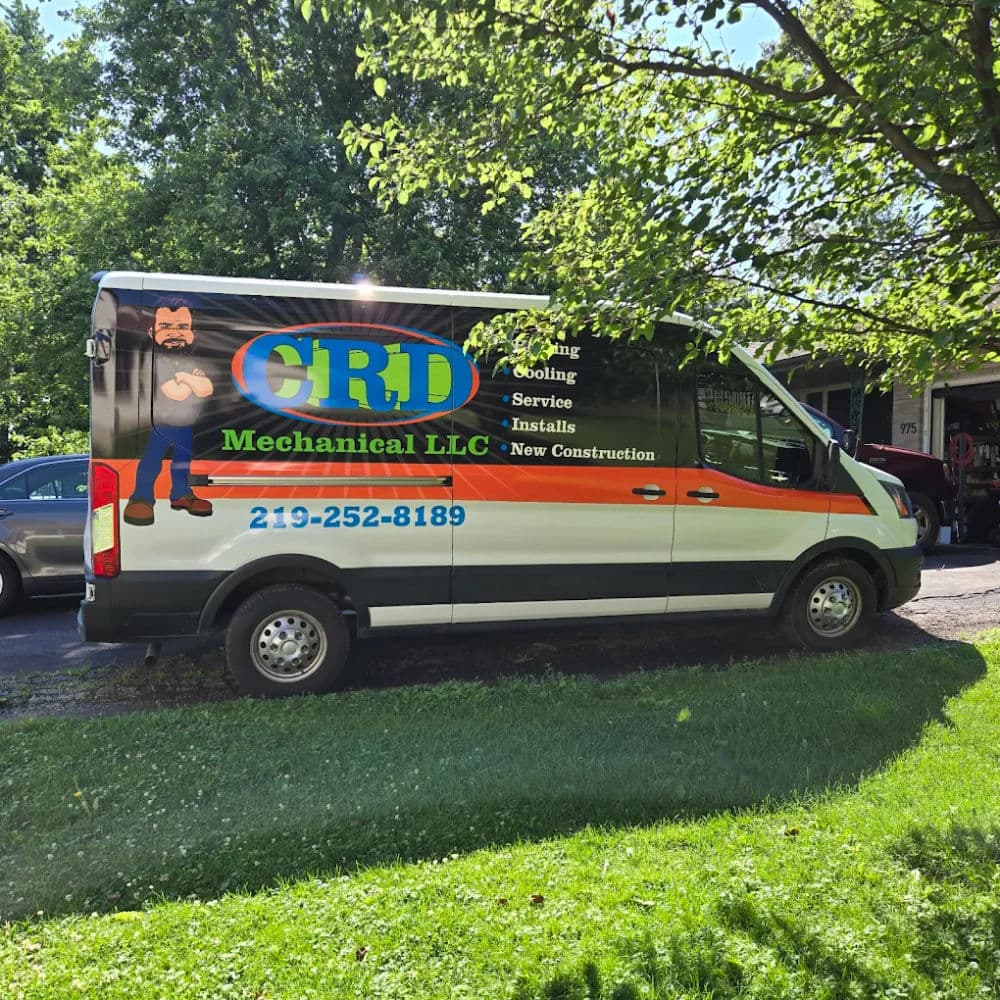 GRD Mechanical LLC service van parked outside, featuring HVAC services and contact information.